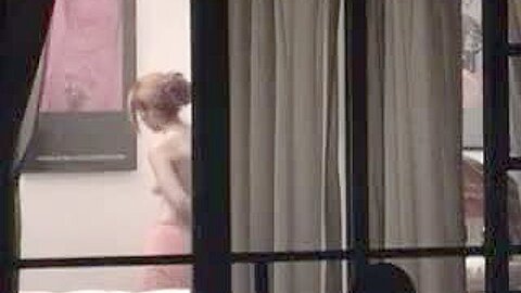 Sexy blonde stripping next to a window caught on voyeur cam | watch  HD candid camera sex video for free